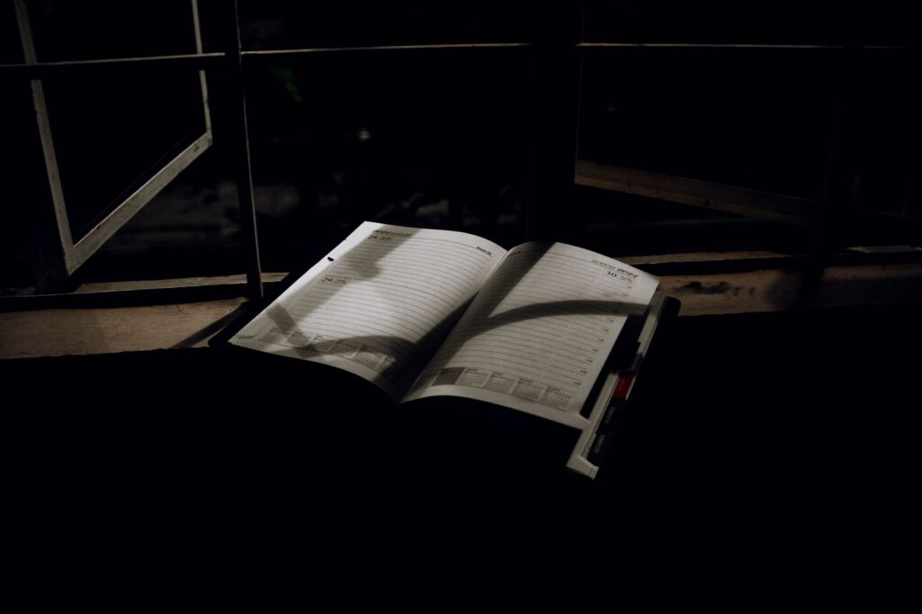 an open planner on a window sill